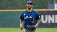 Toronto Blue Jays' Kevin Kiermaier runs to the dugout during a rainstorm during the third inning of a baseball game against the Cleveland Guardians in Cleveland, Sunday, June 23, 2024. (AP Photo/Phil Long)