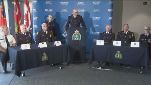Police are shown at a news conference in Newmarket on July 31. A father and son have been arrested in connection with a planned terrorist attack in the Toronto area, police say. (CP24)