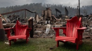 Melted chairs are shown outside of the burned Maligne Lodge after wildfires encroached into Jasper, Alta., on Friday, July 26, 2024. THE CANADIAN PRESS/Amber Bracken