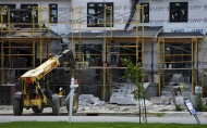 Construction workers build new row homes in Ottawa on June 25.  THE CANADIAN PRESS/Sean Kilpatrick