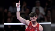 Canada's Wyatt Sanford celebrates after defeating Bulgaria's Radoslav Rosenov in their men's 63.5 kg preliminary boxing match at the 2024 Summer Olympics, Monday, July 29, 2024, in Paris, France. (AP Photo/John Locher) 