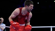 Canada's Wyatt Sanford, celebrates after defeating Uzbekistan's Ruslan Abdullaev in their men's 63.5kg quarterfinal boxing match at the 2024 Summer Olympics, Thursday, Aug. 1, 2024, in Paris, France. (AP Photo/John Locher) 