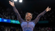 Simone Biles, of the United States, celebrates after performing in the floor exercise during the women's artistic gymnastics all-around finals in Bercy Arena at the 2024 Summer Olympics, Thursday, Aug. 1, 2024, in Paris, France. (AP Photo/Charlie Riedel)