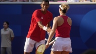Canada's Felix Auger-Aliassime and Gabriela Dabrowski celebrate a point during the mixed doubles bronze-medal match against Demi Schuurs and Wesley Koolhoof of the Netherlands at the Summer Olympics in Paris on Friday, Aug.2, 2024. THE CANADIAN PRESS/Adrian Wyld