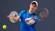 FILE - Denis Shapovalov, of Canada, hits a return to Stefanos Tsitsipas, of Greece, during the Miami Open tennis tournament Saturday, March 23, 2024, in Miami Gardens, Fla. THE CANADIAN PRESS/AP-Lynne Sladky