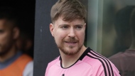 FILE - Jimmy Donaldson, the popular YouTube video maker who goes by MrBeast, wears a Lionel Messi jersey as he stands in a sideline box at the start of an MLS soccer match between Inter Miami and CF Montreal, March 10, 2024, in Fort Lauderdale, Fla. (AP Photo/Rebecca Blackwell, File)