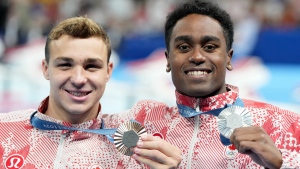 Canada's Josh Liendo, right, of Toronto, poses with the silver medal he won alongside fellow Canadian Ilya Kharun, of Montreal, who won bronze, both in the 100m men's butterfly final during the 2024 Summer Olympic Games, in Nanterre, France, Saturday, Aug. 3, 2024. THE CANADIAN PRESS/Christinne Muschi