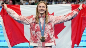 Canada's Summer McIntosh, of Toronto, celebrates with her gold medal won in the 200m women's individual medley final during the 2024 Summer Olympic Games, in Nanterre, France, Saturday, Aug. 3, 2024. THE CANADIAN PRESS/Christinne Muschi