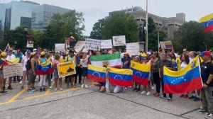Demonstrators gathered at Queen's Park protest the Venezuelan election results and demand a stronger response from Ottawa, in Toronto, Saturday, Aug. 3, 2024. THE CANADIAN PRESS/Sheila Reid