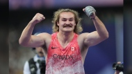 Ethan Katzberg, of Nanaimo, B.C., celebrates after winning gold in the men's hammer throw event at the 2024 Summer Olympics, Sunday, Aug. 4, 2024, in Saint-Denis, France. THE CANADIAN PRESS/Nathan Denette