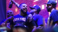 FILE - Drake reacts on stage in Jurassic Park as the Toronto Raptors defeat the Golden State Warriors in Game 6 NBA Finals to win the NBA Championship, in Toronto on Thursday, June 13, 2019. THE CANADIAN PRESS/Nathan Denette