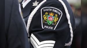 A substitute teacher has been arrested and charged in connection to an assault at a school in Bradford. A service patch is seen on the arm of a senior South Simcoe police officer at a funeral service in Barrie, Ont., Thursday, Oct. 20, 2020. THE CANADIAN PRESS/Christopher Drost