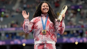 Canada's Camryn Rogers celebrates her gold medal won in the women's hammer throw event on the podium at the Summer Olympics in Paris, Tuesday, Aug. 6, 2024. THE CANADIAN PRESS/Adrian Wyld