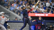 Toronto Blue Jays' Vladimir Guerrero Jr. (27) hits a two-run home run during the fifth inning of MLB baseball action against the Baltimore Orioles, in Toronto, on Thursday, August 8, 2024. THE CANADIAN PRESS/Christopher Katsarov