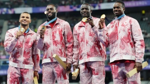 Canada's men's 4 x 100m relay team Andre De Grasse, left to right, Brendon Rodney, Jerome Blake and Aaron Brown celebrate with their gold medals on the podium during the Paris Summer Olympics in Saint-Denis, France, Friday, Aug. 9, 2024. THE CANADIAN PRESS/Nathan Denette