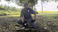 Zachary Chejanovski, an interagency python management coordinator with the Florida Wildlife Commission, holds down a nine-foot-long Burmese python during a demonstration of how to safely capture snakes Friday, Aug. 9, 2024, the first day of the Florida Python Challenge, in Everglades Holiday Park in Broward County, Fla. (AP Photo/Marta Oliver Craviotto)