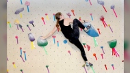 Rachel Chalik climbs a boulder problem at Philadelphia Rock Gym in Wyncote, Pa., on Wednesday, July 31, 2024. (AP Photo/Jonathan Elderfield)