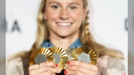 Canada's Summer McIntosh poses with her four medals won in the pool at the 2024 Summer Olympics, Monday, Aug. 5, 2024 in Paris, France. Nine gold medals and 27 total medals were both records for Canada at a non-boycotted Summer Olympics to surpass previous highs set in Tokyo three years ago and 1992 in Barcelona. THE CANADIAN PRESS/Christinne Muschi