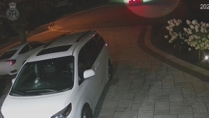 This image taken from a video released by police shows a bullet hole in the windshield of a vehicle parked outside a Markham home on Aug. 9. (York Regional Police)