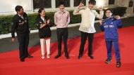 Olympic double gold medalist in gymnastics, Carlos Yulo, right, poses with President Ferdinand Marcos Jr., left, First Lady Liza Araneta Marcos, second from left, and their sons during a welcome ceremony at the Malcañang presidential palace in Manila, Philippines on Tuesday, Aug. 13, 2024. (AP Photo/Basilio Sepe, Pool)