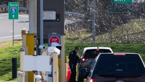 A U.S. Customs and Border Protection officer speaks to a British Columbia motorist at the Peace Arch border crossing in Blaine, Wash., across the Canada-U.S. border from Surrey, B.C., on November 8, 2021. THE CANADIAN PRESS/Darryl Dyck