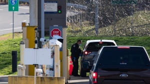 A U.S. Customs and Border Protection officer speaks to a British Columbia motorist at the Peace Arch border crossing in Blaine, Wash., across the Canada-U.S. border from Surrey, B.C., on November 8, 2021. THE CANADIAN PRESS/Darryl Dyck