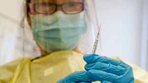 FILE - A physician assistant prepares a syringe with the Mpox vaccine for a patient at a vaccination clinic in New York on Friday, Aug. 19, 2022. (AP Photo/Mary Altaffer, File)