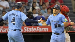 Toronto Blue Jays' Daulton Varsho is congratulated by George Springer (4) after hitting a three-run home run in the fifth inning of a baseball game against the Los Angeles Angels Wednesday, Aug. 14, 2024, in Anaheim, Calif. (AP Photo/Jayne-Kamin-Oncea)