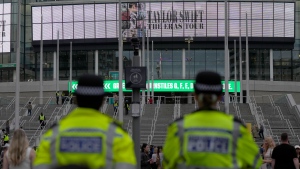 Police officers watch the arrival of Taylor Swift fans at Wembley Stadium in London, Thursday, Aug. 15, 2024 at the first day of five concerts of Taylor Swift's Eras Tour.(AP Photo/Alastair Grant)