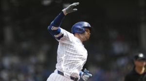 Chicago Cubs' Ian Happ celebrates while rounding third base after hitting a solo home run during the first inning of a baseball game against the Toronto Blue Jays in Chicago, Saturday, Aug. 17, 2024. (AP Photo/Paul Beaty)