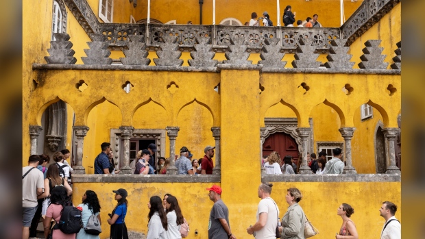 Tourists queue to visit the interior of the 19th century Pena Palace in Sintra, Portugal, Wednesday, Aug. 14, 2024. (AP Photo/Ana Brigida)