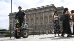 A police officer on a Segway patrols Sweden's parliament in Stockholm, Thursday Aug. 17, 2023. (Fredrik Sandberg/TT News Agency via AP, File)