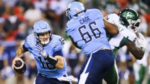 Toronto Argonauts quarterback Chad Kelly (12) runs under pressure during first half CFL action against the Saskatchewan Roughriders, in Toronto, on Thursday, August, 22, 2024. THE CANADIAN PRESS/Christopher Katsarov