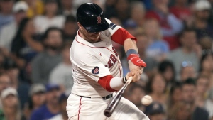 Boston Red Sox's Danny Jansen connects for an RBI single in the eighth inning of a baseball game against the Texas Rangers at Fenway Park, Wednesday, Aug. 14, 2024, in Boston. (AP Photo/Charles Krupa)