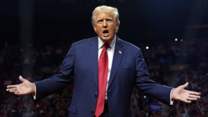 Republican presidential nominee former President Donald Trump gestures at a campaign rally at the Desert Diamond Arena, Friday, Aug. 23, 2024, in Glendale, Ariz. (AP Photo/Evan Vucci)