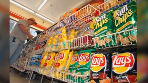 FILE - A customer makes a purchase at a convenience store in Boston in this July 12, 2005 file photo. (AP Photo/Lisa Poole, file)