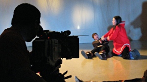 A camerman films Lamech Kadloo of Pond Inlet playing the role of Kiviuq in a scene where many of his fellow hunters are drowned while kayaking when a storm comes up. APTN is launching a channel with programming primarily in Indigenous languages next week. The TV network announced the channel in May as part of an application to consolidate its four programming feeds into two -- one main channel and "APTN Languages."(CP PHOTO/Bob Weber)