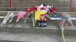 A fan-made memorial for Johnny Gaudreau, with flowers and Calgary Flames garments, is seen on the steps of the Saddledome in Calgary, Alta., Friday, Aug. 30, 2024. Fans, friends and athletes from the hockey world and beyond joined in an outpouring of love and sorrow for the family of Johnny and Matthew Gaudreau. THE CANADIAN PRESS/Lauren Krugel