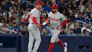 Philadelphia Phillies' Kyle Schwarber, right, celebrates hitting a solo home run in the fourth inning of a baseball game against the Toronto Blue Jays in Toronto on Tuesday Sept. 3, 2024. THE CANADIAN PRESS/Jon Blacker