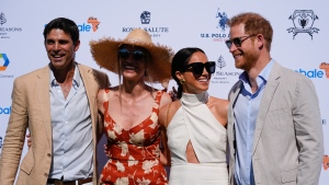 Prince Harry, right, and wife Meghan Markle, Duchess of Sussex, pose for photos with Argentine professional polo player Ignacio 'Nacho' Figueras, left, and his wife Delfina Blaquier, as they arrive for the 2024 Royal Salute Polo Challenge to Benefit Sentebale on April 12, 2024, in Wellington, Fla. (AP Photo/Rebecca Blackwell)