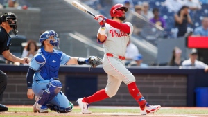 Philadelphia Phillies designated hitter Kyle Schwarber (12) hits a solo-home run in the first inning interleague MLB baseball action against the Toronto Blue Jays in Toronto on Wednesday, September 4, 2024. THE CANADIAN PRESS/Cole Burston