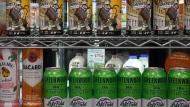 Beer cans are stacked in front a display of milk at a convenience store in Toronto, Thursday, Dec. 14, 2023. THE CANADIAN PRESS/Chris Young