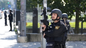 Police officers patrol near a scene after police fired shots at a suspicious person near the Israeli Consulate and a museum on the city's Nazi-era history in Munich, Germany, Thursday, Sept. 5, 2024. (AP Photo/Matthias Schrader)