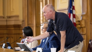 State Election Board member Rick Jeffares asks the crowd to settle down during a hastily planned State Election Board meeting at the Capitol in Atlanta, July 12, 2024. (Arvin Temkar/Atlanta Journal-Constitution via AP, File)