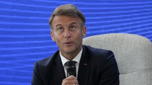 French President Emmanuel Macron addresses attendees at the Youth and Artificial Intelligence Forum at the InGrid-Schneider Electric LLC Company, in Novi Sad, Serbia, Friday, Aug. 30, 2024.(AP Photo/Darko Vojinovic)