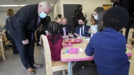 Ontario Premier Doug Ford, left, visits a daycare centre after reaching and agreement with the federal government in $10-a-day child-care program deal in Brampton, Ont., on March 28, 2022. THE CANADIAN PRESS/Nathan Denette