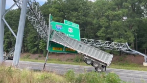 Trailer caught on overhead sign blocks U.S. highwa