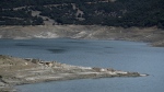 Buildings are seen in the sunken Kallio village that's resurfaced from the artificial Mornos Lake, some 200 kilometers (125 miles) northwest from Athens, central Greece, on Thursday, Sept. 5, 2024. (AP Photo/Thanassis Stavrakis)