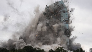 The Hertz Tower, that was heavily damaged after Hurricanes Laura and Delta in 2020, is imploded in Lake Charles, La., Saturday, Sept. 7, 2024. (AP Photo/Gerald Herbert)