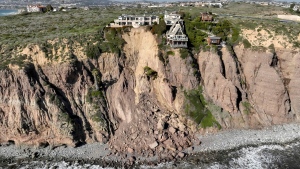 Luxury homes in danger of falling due to a landslide following heavy rainfall, in Dana Point, California, on February 15. (Ted Soqui/Sipa USA/AP via CNN Newsource)
